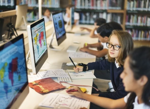 Girls Studying Map Class Concept