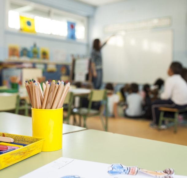 pens and paints on table in a primary school class